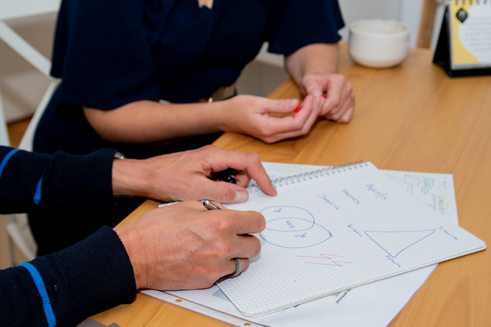 A couch sitting in a living room next to a plant