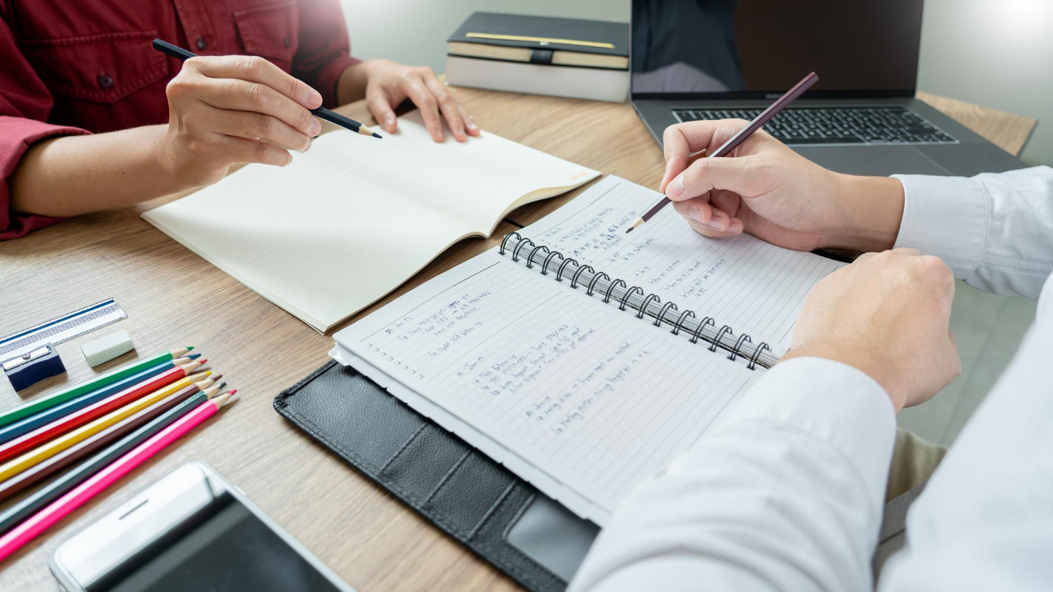Calming spa setup featuring a jade roller, gua sha stone, and candle for relaxation and skincare.